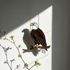 Handmade stained glass bald eagle suncatcher, realistic bird window hanging with brown and white glass, patriotic gift for dad or veteran, creating colored shadows.