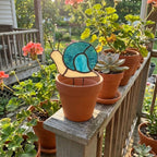 Cute stained glass snail suncatcher hanging on window, whimsical cottagecore decor for plant lovers, colorful glass animal art handmade in Vietnam, goblincore aesthetic gift.