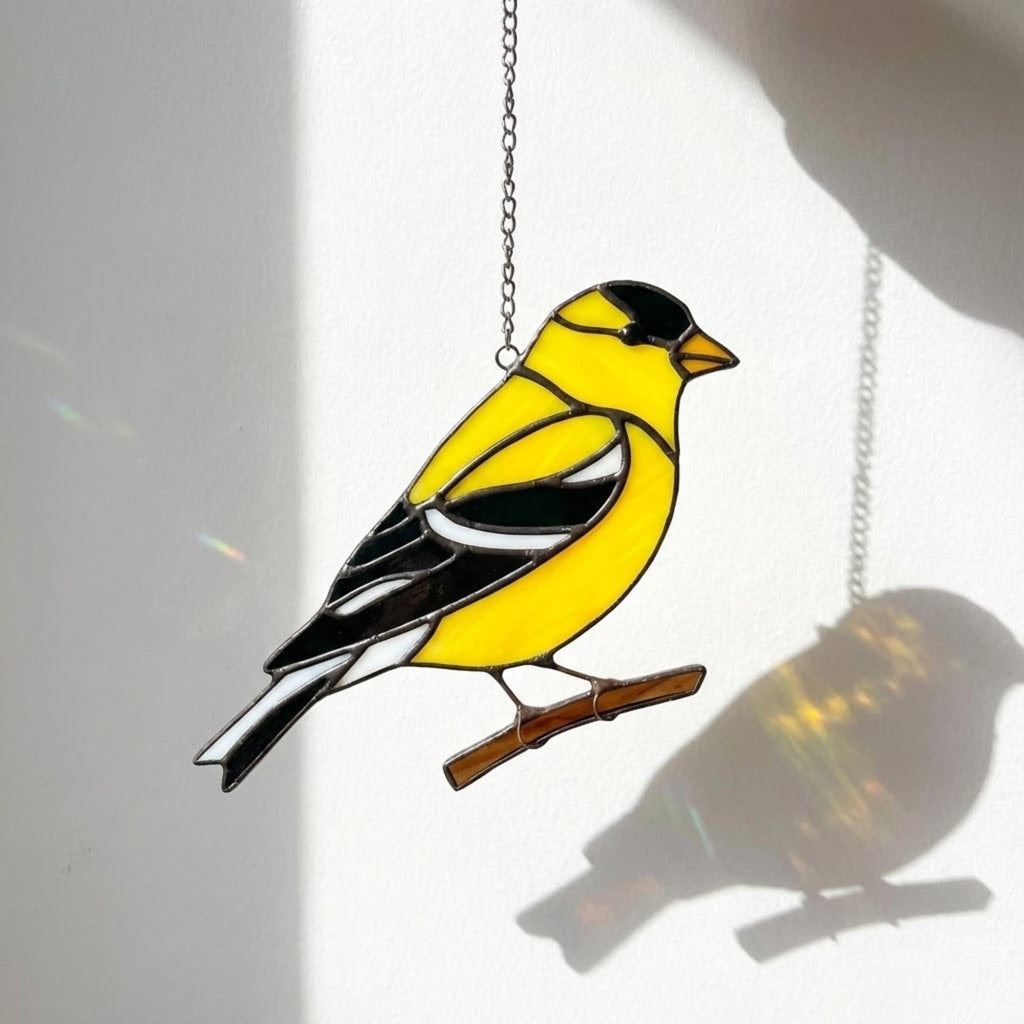 Stained glass American Goldfinch suncatcher hanging on window casting yellow shadows, vibrant yellow bird ornament for birdwatchers, handmade state bird gift for New Jersey Iowa Washington by LuzyGlassArt.