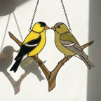 Stained glass American Goldfinch suncatcher hanging on window casting yellow shadows, vibrant yellow bird ornament for birdwatchers, handmade state bird gift for New Jersey Iowa Washington by LuzyGlassArt.