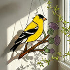 Stained glass American Goldfinch suncatcher hanging on window casting yellow shadows, vibrant yellow bird ornament for birdwatchers, handmade state bird gift for New Jersey Iowa Washington by LuzyGlassArt.