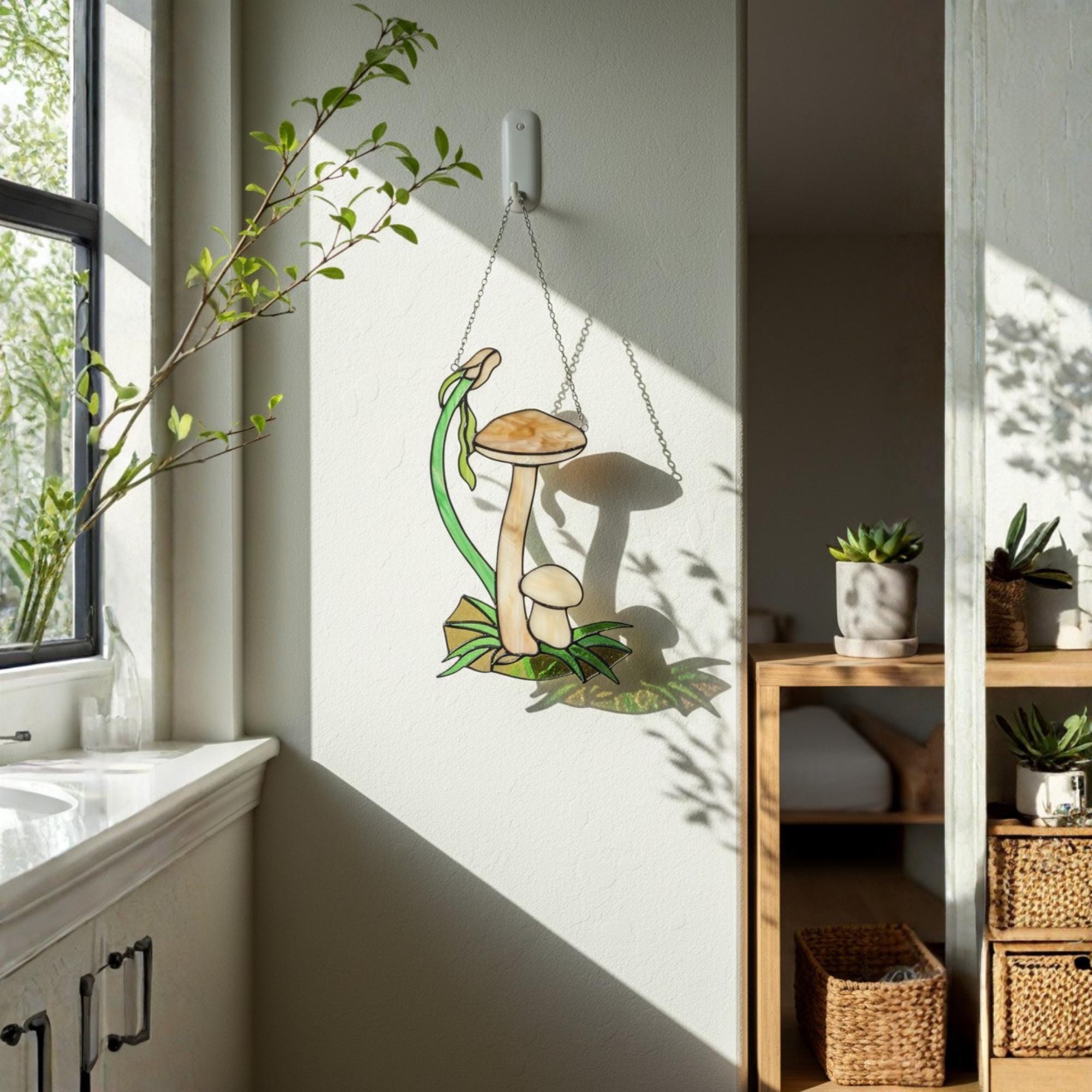 Handmade stained glass mushroom suncatcher with green grass base, colorful fungi window hanging, cottagecore forest decor for plant lovers.