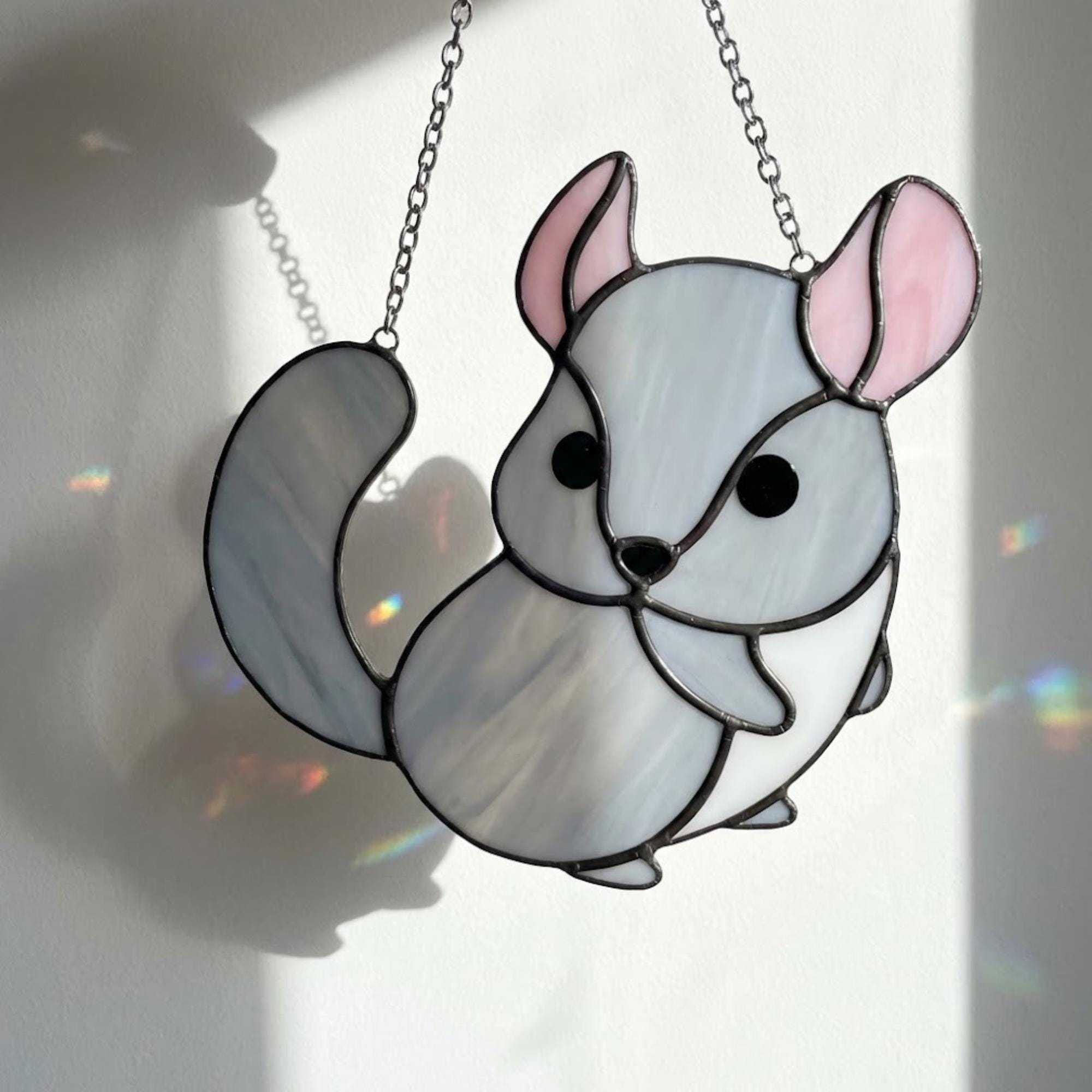 Handmade stained glass chinchilla suncatcher, cute white and grey rodent holding a branch, kawaii animal window hanging for pet lovers.