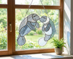 Handmade stained glass manatee suncatcher, mother and baby sea cow swimming, blue and white textured glass, ocean nursery decor, coastal window art.