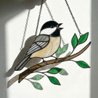 Stained glass Black-capped Chickadee bird suncatcher on branch hanging on window, handmade Maine and Massachusetts state bird gift, realistic nature decor by LuzyGlassArt.