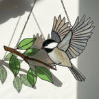 Stained glass Black-capped Chickadee bird suncatcher on branch hanging on window, handmade Maine and Massachusetts state bird gift, realistic nature decor by LuzyGlassArt.