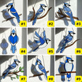Stained glass Blue Jay bird suncatcher on branch hanging on window casting blue shadows, handmade realistic nature decor for birdwatchers by LuzyGlassArt.