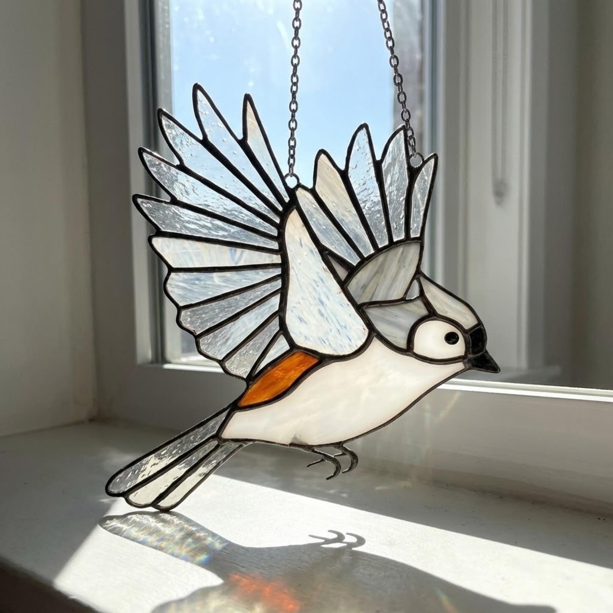 Stained glass Black-capped Chickadee bird suncatcher on branch hanging on window, handmade Maine and Massachusetts state bird gift, realistic nature decor by LuzyGlassArt.
