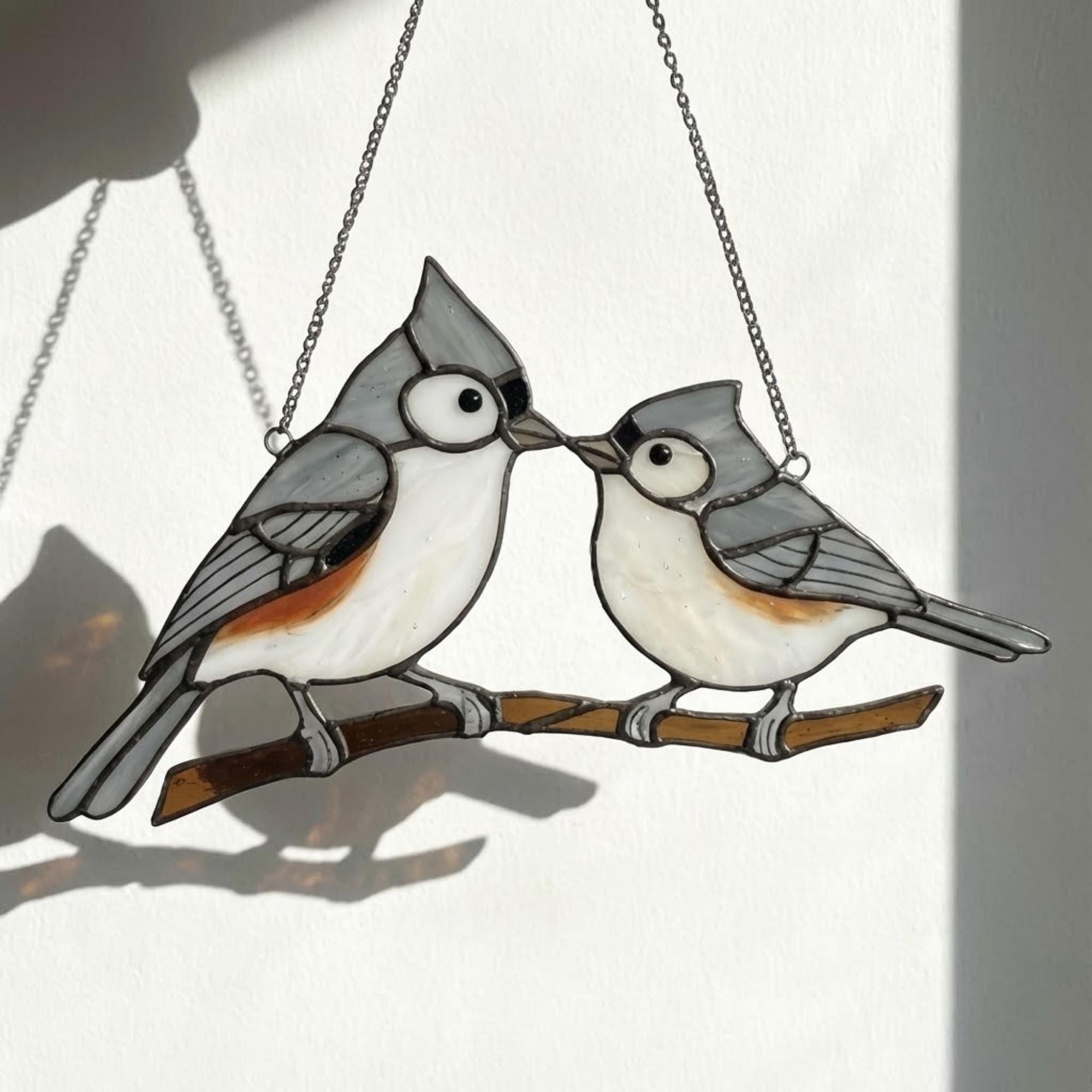 Stained glass Black-capped Chickadee bird suncatcher on branch hanging on window, handmade Maine and Massachusetts state bird gift, realistic nature decor by LuzyGlassArt.