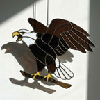 Handmade stained glass bald eagle suncatcher, realistic bird window hanging with brown and white glass, patriotic gift for dad or veteran, creating colored shadows.