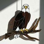 Handmade stained glass bald eagle suncatcher, realistic bird window hanging with brown and white glass, patriotic gift for dad or veteran, creating colored shadows.