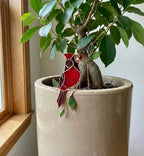 Handmade stained glass snail plant stake with amber shell and green leaves, cute cottagecore garden decor for indoor pots, gift for plant lover.