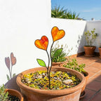 Colorful stained glass heart plant stakes with green leaves in a flower pot, gift box packaging, garden decor for plant lovers.