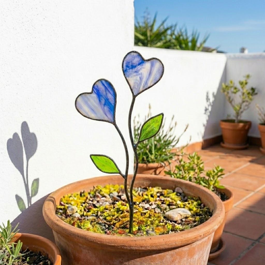 Colorful stained glass heart plant stakes with green leaves in a flower pot, gift box packaging, garden decor for plant lovers.