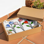 Colorful stained glass heart plant stakes with green leaves in a flower pot, gift box packaging, garden decor for plant lovers.