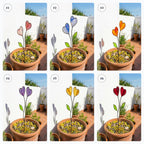 Colorful stained glass heart plant stakes with green leaves in a flower pot, gift box packaging, garden decor for plant lovers.