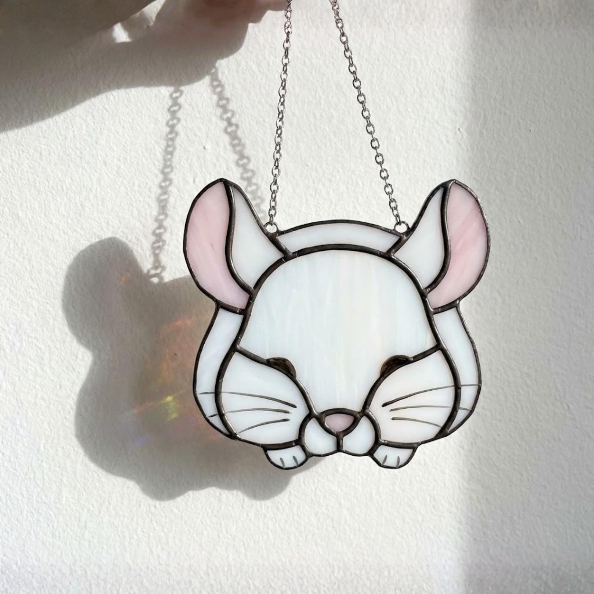 Handmade stained glass chinchilla suncatcher, cute white and grey rodent holding a branch, kawaii animal window hanging for pet lovers.