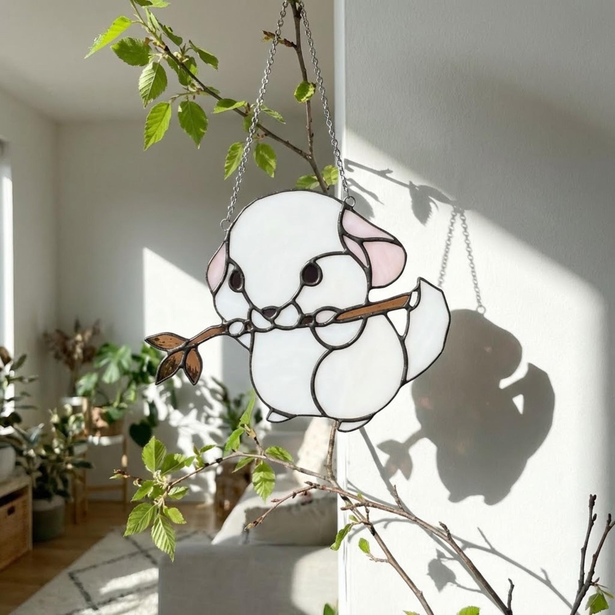 Handmade stained glass chinchilla suncatcher, cute white and grey rodent holding a branch, kawaii animal window hanging for pet lovers.