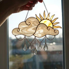 Handmade stained glass sun and cloud suncatcher with hanging crystal raindrops, wispy white glass texture, celestial nursery decor, symbol of hope.