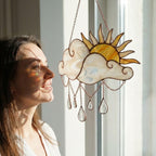 Handmade stained glass sun and cloud suncatcher with hanging crystal raindrops, wispy white glass texture, celestial nursery decor, symbol of hope.