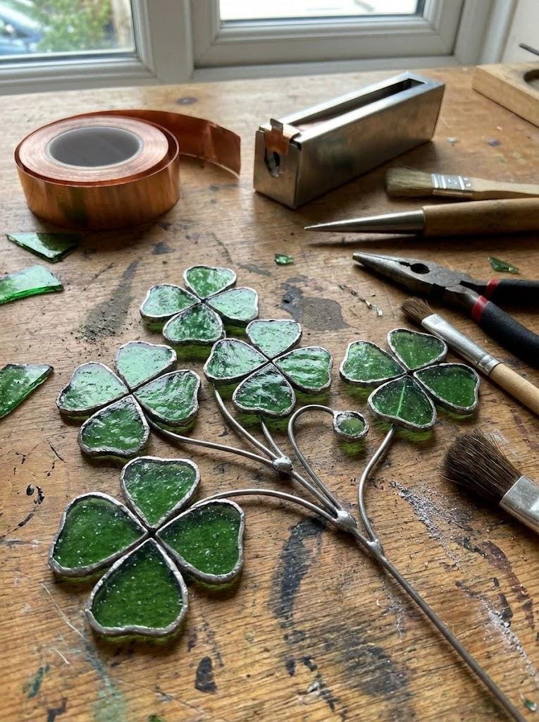 Handmade stained glass four leaf clover sculpture standing on solid wood base, green shamrock lucky gift for desk decor, feng shui plant stake.