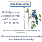 Handmade stained glass plant stakes collection including hummingbird, cardinal, blue jay birds, monarch butterfly, dragonfly, and flowers attached to metal rods for indoor plant pot decoration.