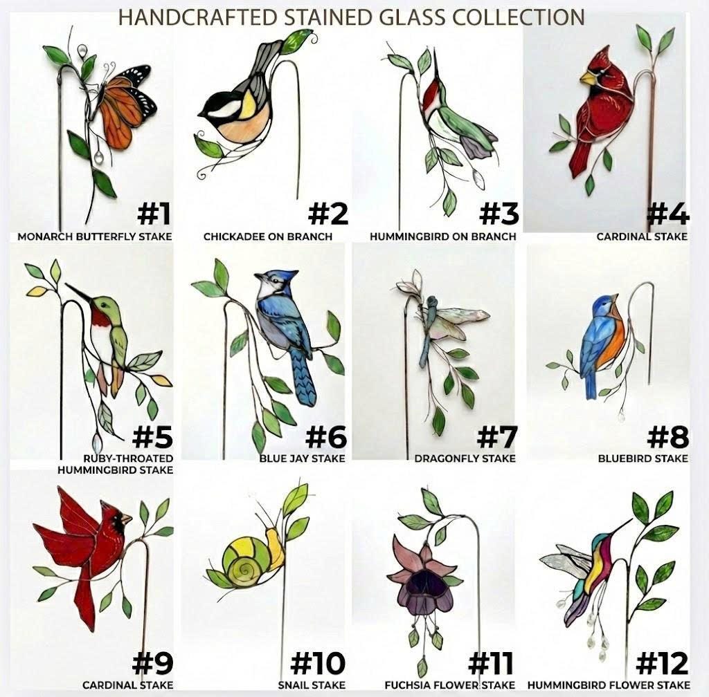Handmade stained glass plant stakes collection including hummingbird, cardinal, blue jay birds, monarch butterfly, dragonfly, and flowers attached to metal rods for indoor plant pot decoration.