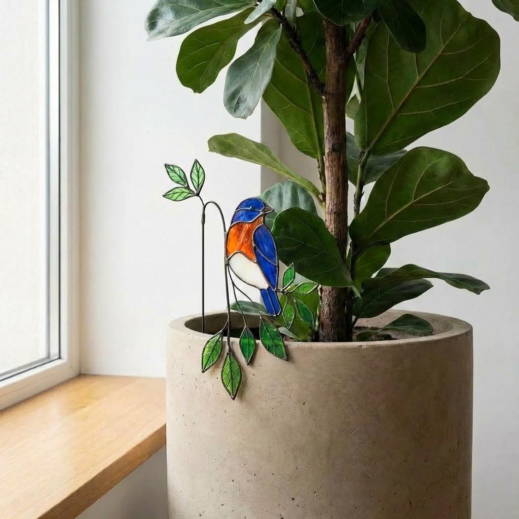 Handmade stained glass snail plant stake with amber shell and green leaves, cute cottagecore garden decor for indoor pots, gift for plant lover.