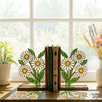 Handmade stained glass white daisy flower bookends on solid wood bases holding books on a sunlit desk, beautiful cottagecore shelf decor and book lover gift.
