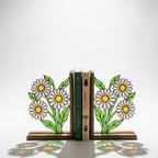 Handmade stained glass white daisy flower bookends on solid wood bases holding books on a sunlit desk, beautiful cottagecore shelf decor and book lover gift.
