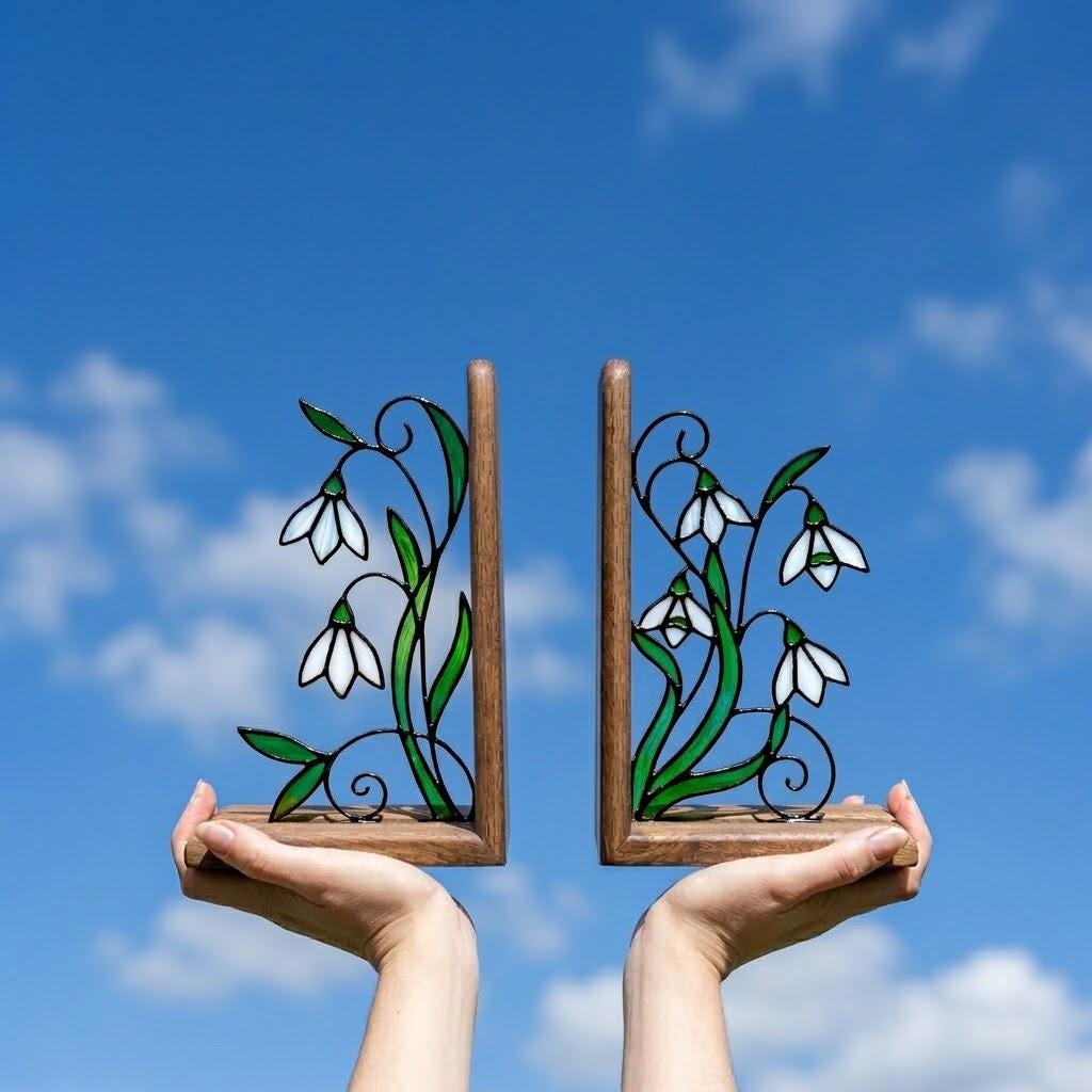Handmade stained glass white snowdrop flower bookends with delicate wirework on solid wood bases, beautiful january birth flower spring shelf decor and book lover gift.