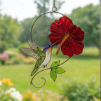 Handmade hummingbird and red hibiscus flower stained glass suncatcher casting vibrant colored shadows, perfect tropical botanical decor and memorial gift for mom.