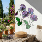 Handcrafted 3D stained glass purple sweet pea flower standing on a solid wooden base casting colored shadows, perfect April birth flower or Mother's Day desk decor gift.