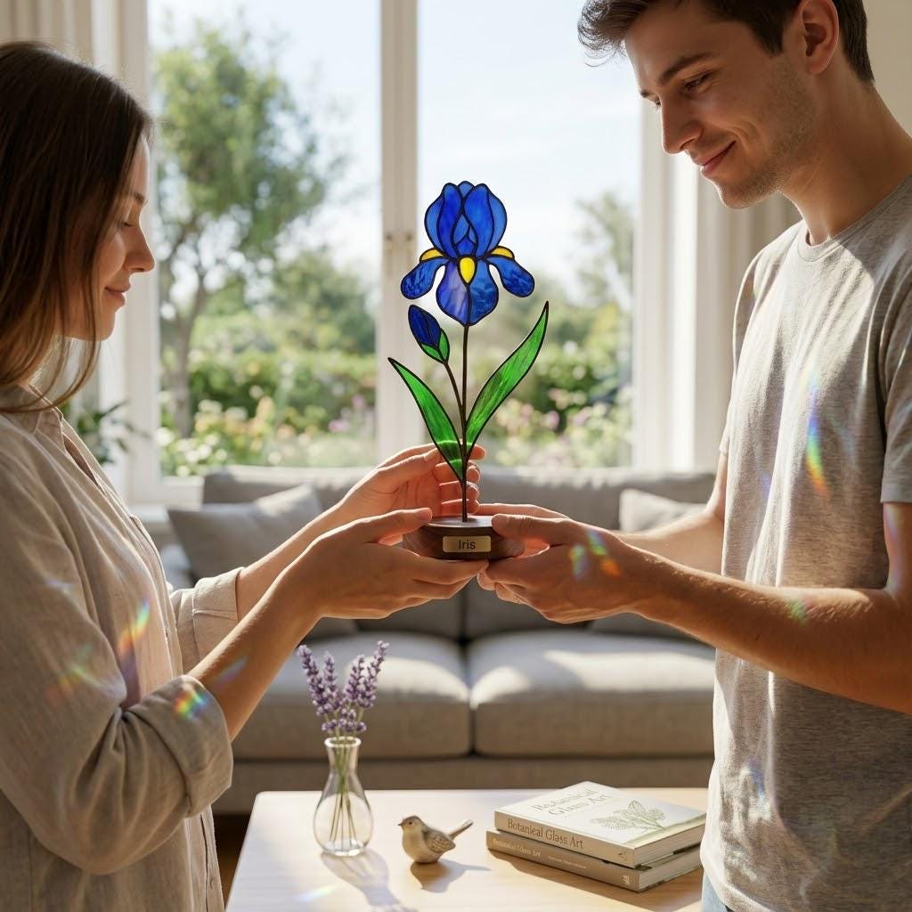 Handcrafted 3D stained glass blue iris flower standing on a wooden base with a brass nameplate, casting colored shadows, perfect Mother's Day desk decor gift.