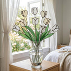 Handcrafted stained glass tulip flowers on long wire stems arranged in a sunlit vase casting colored shadows, perfect everlasting Mother's Day bouquet gift.