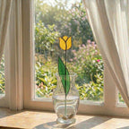 Handcrafted stained glass tulip flowers on long wire stems arranged in a sunlit vase casting colored shadows, perfect everlasting Mother's Day bouquet gift.