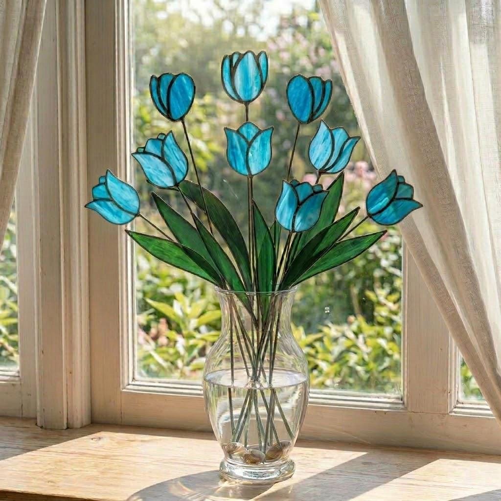 Handcrafted stained glass tulip flowers on long wire stems arranged in a sunlit vase casting colored shadows, perfect everlasting Mother's Day bouquet gift.