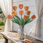Handcrafted stained glass tulip flowers on long wire stems arranged in a sunlit vase casting colored shadows, perfect everlasting Mother's Day bouquet gift.
