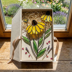 Handcrafted stained glass coneflower black eyed susan family bouquet standing on a custom personalized engraved wooden base casting colored shadows, perfect Mom's garden Mother's Day desk decor gift.