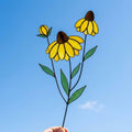 Handcrafted stained glass coneflower black eyed susan family bouquet standing on a custom personalized engraved wooden base casting colored shadows, perfect Mom's garden Mother's Day desk decor gift.