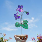 Handmade 3D purple violet stained glass flower casting vibrant colored shadows, available with a custom engraved wooden base or standalone for vase display, perfect for personalized Mother's Day gift and February birth flower desk decor.