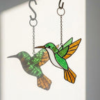 Handmade stained glass hummingbird suncatchers in colorful blue green red purple and yellow, vibrant spring window hanging and meaningful mother's day memorial gift.