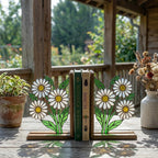 Handmade stained glass white daisy flower bookends on solid wood bases holding books on a sunlit desk, beautiful cottagecore shelf decor and book lover gift.