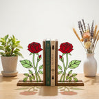 Handmade stained glass red rose flower bookends on solid wood bases casting beautiful colorful shadows, romantic anniversary and book lover gift.