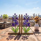 Handmade stained glass purple larkspur flower bookends on premium wood bases casting colorful shadows, beautiful July birth flower botanical shelf decor.