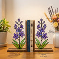 Handmade stained glass purple larkspur flower bookends on premium wood bases casting colorful shadows, beautiful July birth flower botanical shelf decor.
