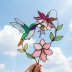Handmade stained glass hummingbird and pink fuchsia flower plant stake decor in a potted plant, beautiful spring suncatcher and Mother's Day gift.