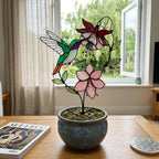 Handmade stained glass hummingbird and pink fuchsia flower plant stake decor in a potted plant, beautiful spring suncatcher and Mother's Day gift.