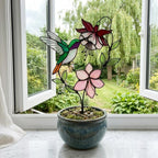 Handmade stained glass hummingbird and pink fuchsia flower plant stake decor in a potted plant, beautiful spring suncatcher and Mother's Day gift.