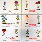 Handcrafted flat stained glass birth month flowers standing on personalized wooden bases, casting colorful light reflections. Perfect Mother's Day or birthday gift.